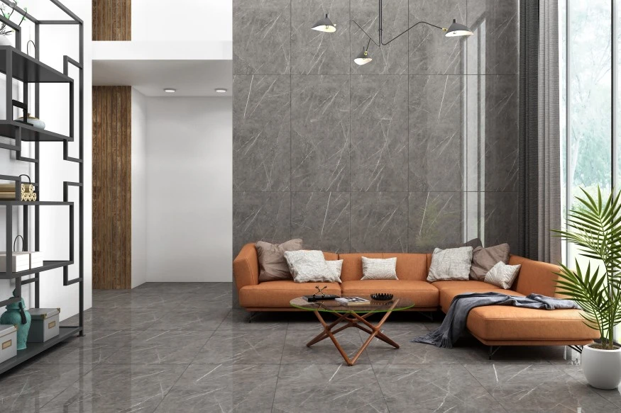Modern living room with cognac coloured couch and grey tiled floor and walls